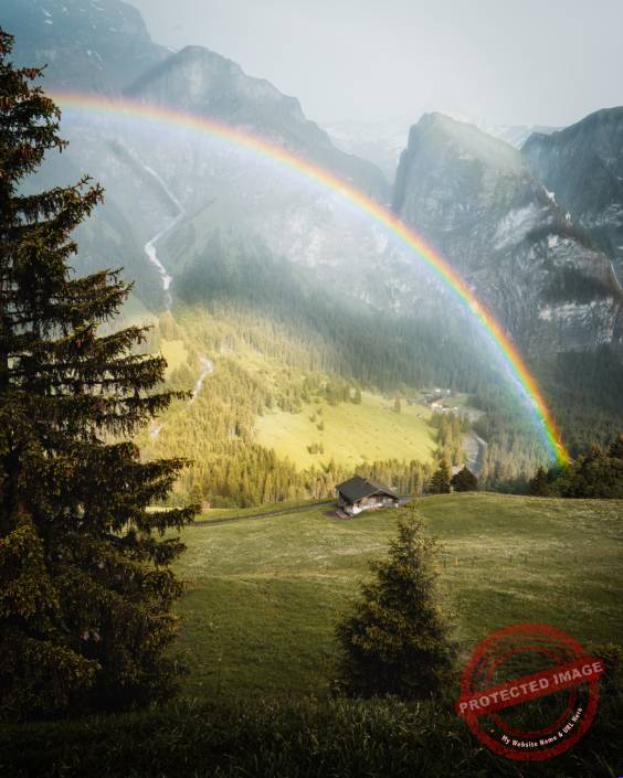 Adelboden Regenbogen im Frühling mit Sonne
